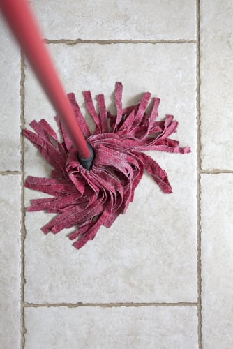 Red kitchen mop being used to clean a floor surface-2